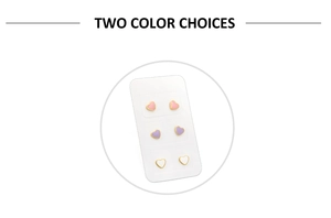 Close-up of heart-shaped earrings in pink, purple and white with gold edges on a card