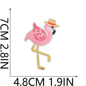 Detailed embroidery texture of pink flamingo patch with straw hat and dimensions