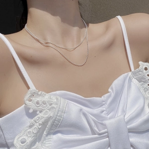 Close-up of minimalist layered S925 sterling silver ball chain necklace for women