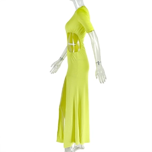 Detail view of neon yellow knitted dress featuring waist cut-out and high side slit