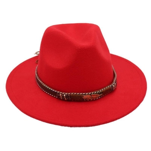 Detail of red wool felt fedora featuring leather band with metal feather and colorful beads