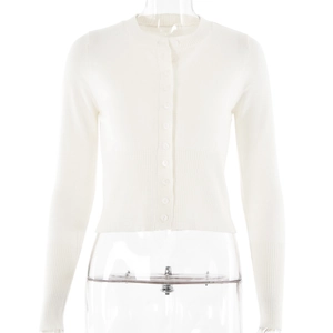Detail of white knit cardigan showing button closure and ribbed cuffs texture