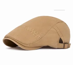 Detailed khaki newsboy cap featuring side embroidery and adjustable metal buckle strap