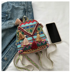 Close-up of colorful geometric embroidery and tassel details on a mini ethnic backpack