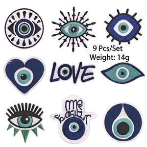 Detailed view of 9-piece blue evil eye embroidered iron-on patches showing texture