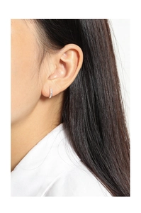 Close-up of minimalist S925 sterling silver hoop earrings with pavé set zircons on ear