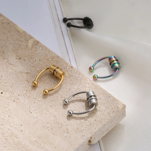 Macro shot of magnetic stainless steel nose rings in silver, gold, black and rainbow finish
