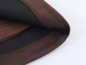 Detail shot of the two-tone brown and black fabric with precise double-needle stitching