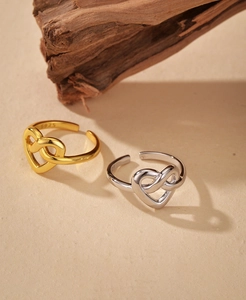 Close-up of S925 sterling silver intertwined heart rings in gold and silver finish