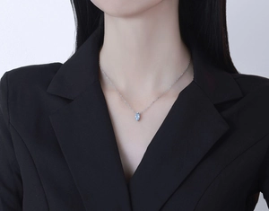 Elegant marquise cut light blue zircon pendant on a thin silver chain shown on model