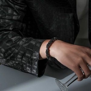 Polished black Byzantine steel chain bracelet for men styled with a leather jacket
