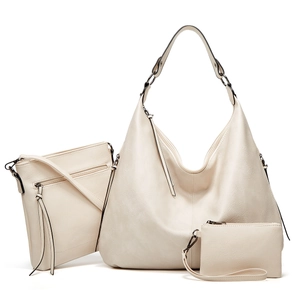 Three-piece beige hobo bag set including large tote, crossbody bag, and wristlet wallet