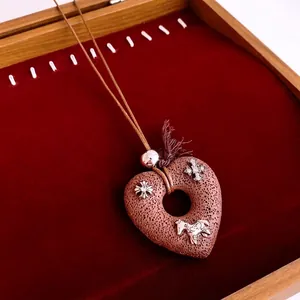 Vintage heart lava stone pendant necklace with silver cross and horse charms on velvet
