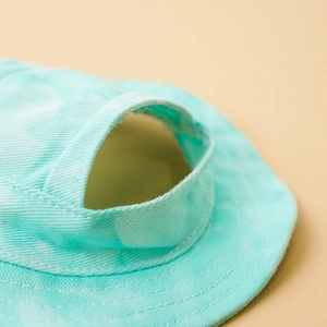 Detail of mint green canvas pet sun hat with top ponytail holes and adjustable strap