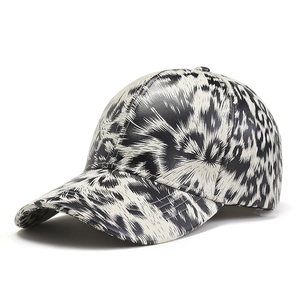 Leopard print faux leather baseball cap with black and white abstract textured pattern