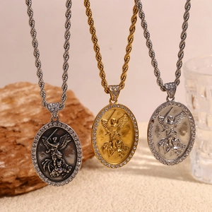 Three 18K gold and silver angel pendants with rhinestones on twisted rope chains
