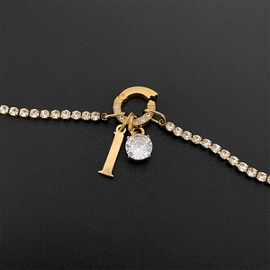 Titanium steel tennis chain necklace featuring a gold letter I and a sparkling crystal pendant