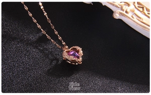 Detailed side view of heart-shaped pink crystal pendant with rose gold plating