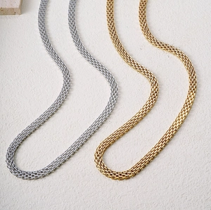 Thick woven chain necklace in gold and silver finish with high-polish metallic texture