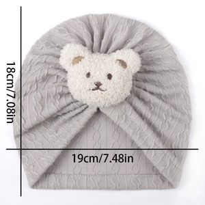 Detailed view of grey baby turban hat with bear plush showing 18x19cm dimensions