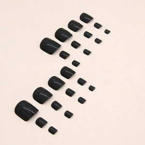 Glossy black press-on toe nails set in various sizes for a sleek and cool pedicure look