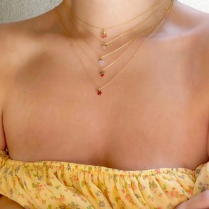 Layered gold necklaces with colorful fruit pendants like cherry and strawberry for women