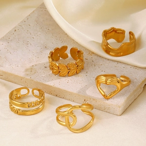 5-piece gold heart and leaf open ring set displayed on elegant silk and stone