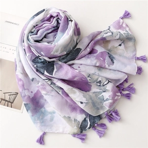 Detailed view of purple floral scarf featuring artistic ink print and handmade tassels