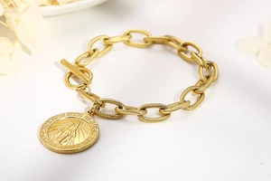Detail of gold-plated Virgin Mary coin pendant and T-bar toggle clasp on a chain bracelet
