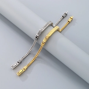 Close-up of gold and silver stainless steel dragon scale bracelets with cloud patterns