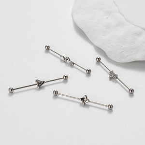 Industrial barbell piercing in 316L stainless steel with snake and crown designs