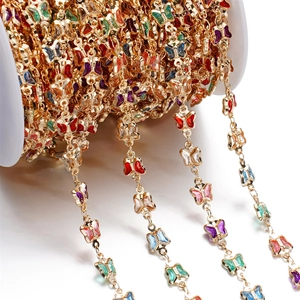 Macro detail of DIY butterfly crystal chain with gold-plated copper and colorful glass