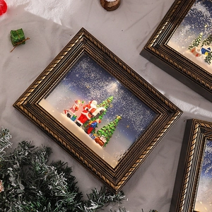 Detailed close-up of three bronze vintage Christmas light boxes with snowy Santa scenes