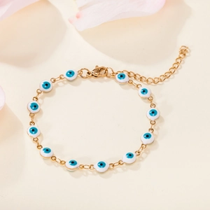 Detail of 18K gold plated evil eye bracelet with blue enamel beads and lobster clasp