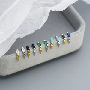 Detailed macro view of punk style geometric stud earrings with colorful zircon stones