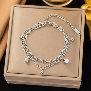 Double-layer stainless steel bracelet with geometric beads on a metal jewelry box
