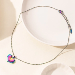 Detail of heart pendant necklace in iridescent rainbow finish with lobster clasp