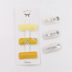 Detailed set of six yellow floral fabric BB hair clips with metal snap backings