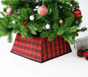 Detail of red and black plaid Christmas tree collar with a festive decorative base