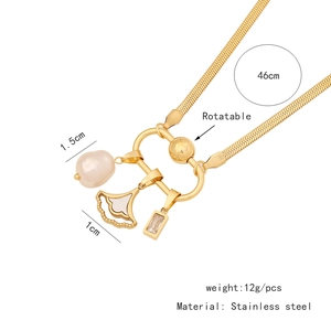 Detail of stainless steel snake chain with rotatable pearl, leaf and zircon pendants