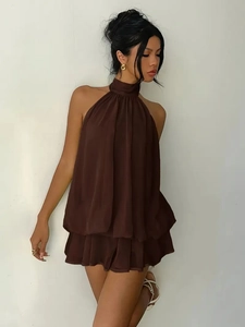Detail of dark brown chiffon halter neck dress with pleated collar and tiered wavy hem