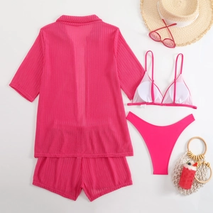 Flat lay of rose red 4-piece swimwear set with textured shirt, shorts and bikini set