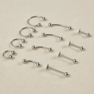 Detailed set of silver stainless steel body piercing jewelry including circular barbells