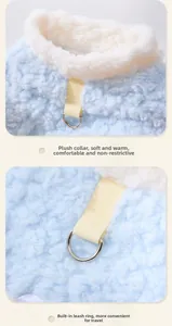 Detail of soft blue plush pet vest showing thick white collar and metal D-ring buckle