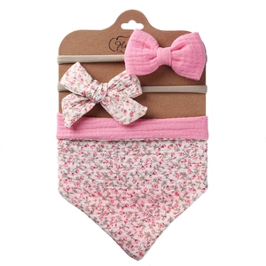 Three-piece baby set including cotton floral bib and matching bow headbands on display card