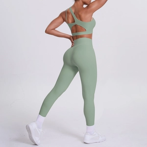 Sage green one-shoulder yoga set showing open back detail and high-waist leggings