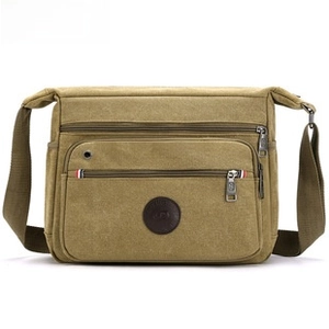 Detail view of khaki canvas sports waist bag with multiple pockets and adjustable strap