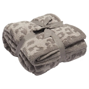 Soft grey leopard print plush blanket folded with a silk ribbon gift bow wrapping