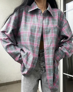 Close-up of pink and blue flannel plaid shirt texture with single-breasted buttons