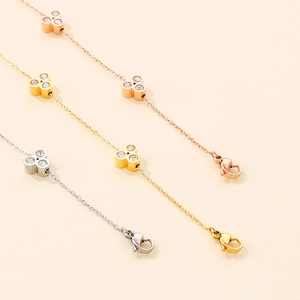 Detailed view of stainless steel clover bracelets in rose gold, gold, and silver finishes